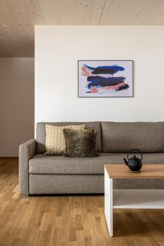 a living room with a couch and a table at MANGGEI-BAU Appartements und Studios in Obertauern