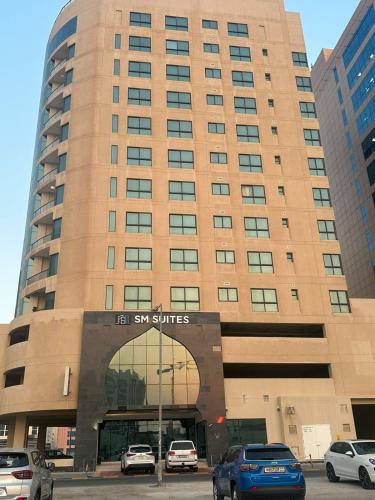 a large building with cars parked in front of it at seef manzil in Seef