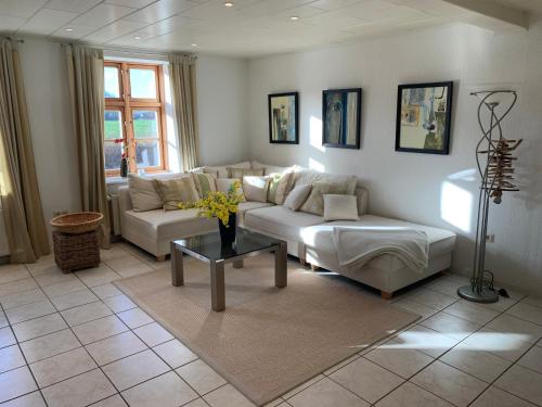 a living room with a couch and a table at Ferienhaus Alte Mühle in Stoltebüll