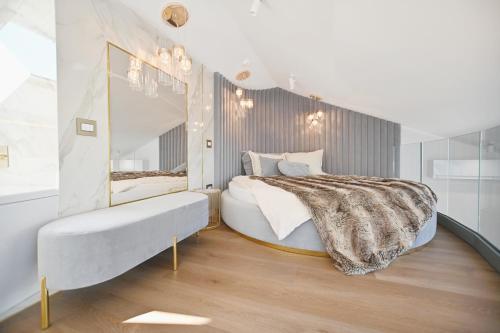 a bedroom with a large bed and a mirror at Prestige Sopot Residence by 3City Rentals in Sopot