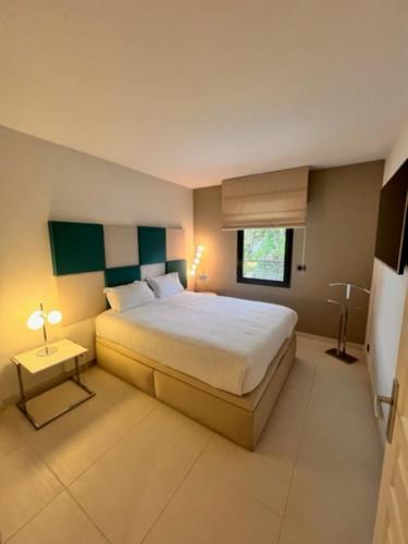 a bedroom with a large bed and a window at Arthur Properties - Montfleury in Cannes