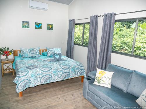1 dormitorio con 1 cama y 1 sofá en Luxury Apartments Nauyaca by Paradiselodge en Platanillo
