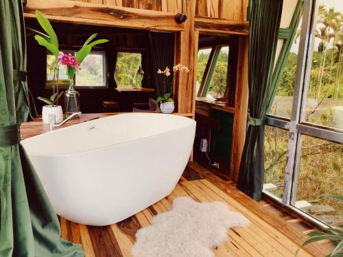 a bath tub in a room with windows at 秘密花園設計villas Sun Moon Lake Secret Garden Design Villas in Yuchi