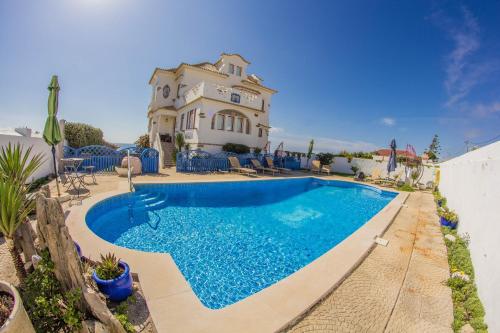 a swimming pool in front of a house at Casal Santa Virginia in Sintra