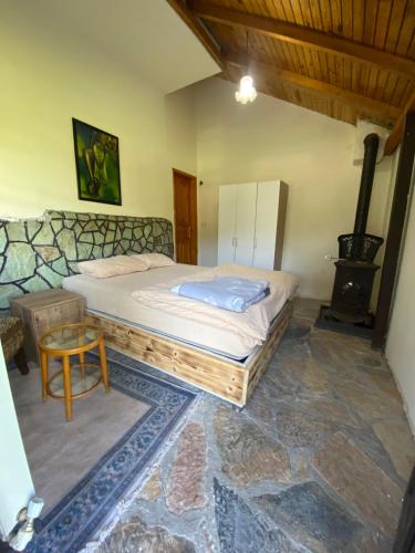 a bedroom with a bed and a wood stove at Abant Taş Konak in Dereceören