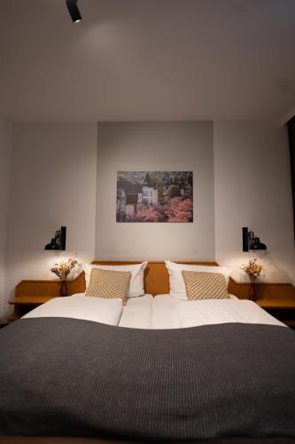 a bedroom with two beds and a painting on the wall at Hotel Stümpelstal in Marburg an der Lahn