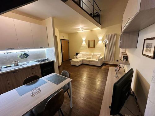Una cocina y una sala de estar con un sofá y una mesa. en Guest House Palazzo Bussi, en Viterbo