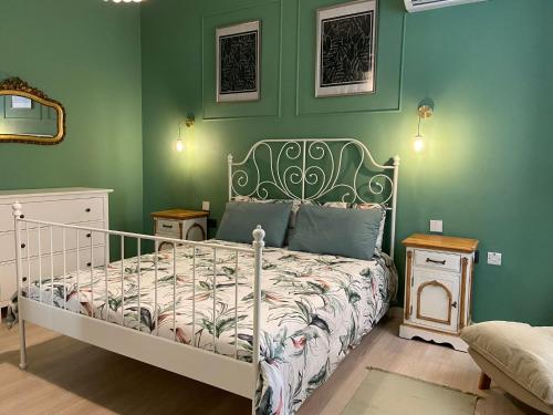a bedroom with a bed in a green wall at Stylish Valletta Apartment in Valletta