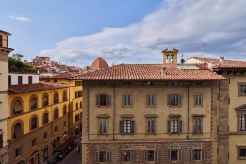 an old building with a clock tower on top of it at Duomo Luxury Florence in Florence