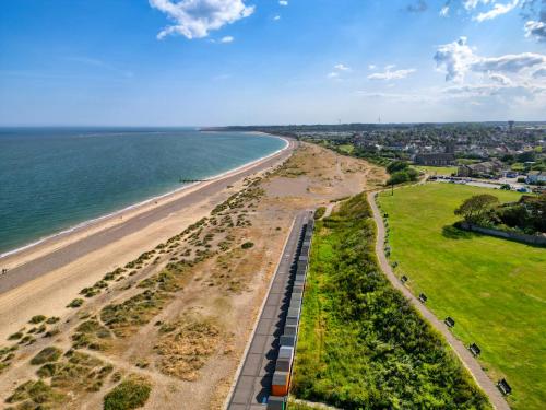 an aerial view of a beach and the ocean at Avocet - Suffolk Coastal Escapes in Pakefield