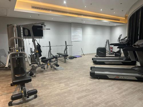 a gym with treadmills and exercise equipment in a room at seef manzil in Seef