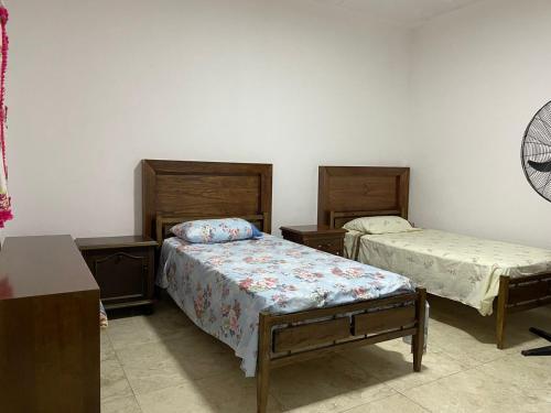 a room with two beds in a room with at el mistol in San Miguel de Tucumán