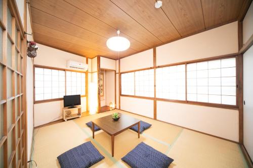 an empty room with a table and a tv at Very convenient to Kyosera Dome Osaka in Osaka
