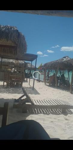 a beach with chairs and umbrellas on the beach at Sol do Paraiso in Jijoca de Jericoacoara