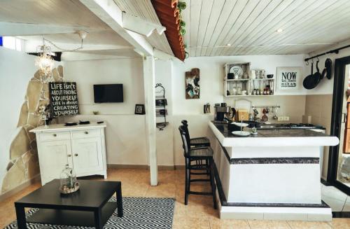 a kitchen with a counter and a table in a room at Finca Vino Tinto 5s in Icod de los Vinos