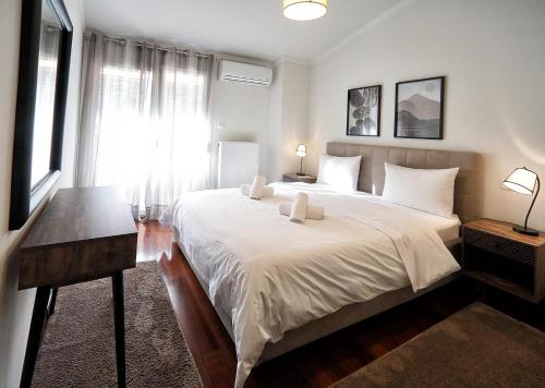 a bedroom with a large bed and a window at Swan Lake Front Apartment in Kastoria