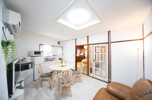 a kitchen and living room with a table and chairs at Very convenient to Kyosera Dome Osaka in Osaka