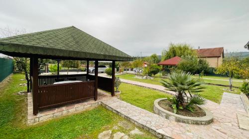 a gazebo with a green roof in a yard at Villa Darija in Danilovgrad