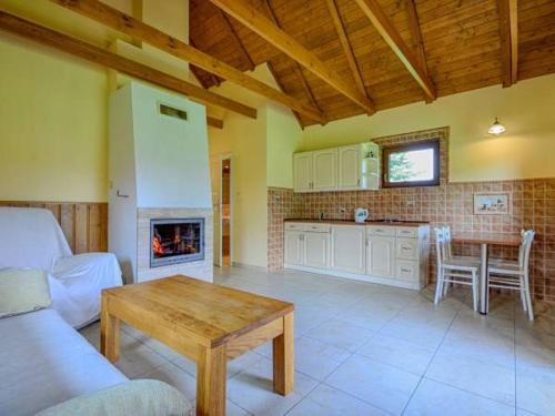 a living room with a couch and a table with a fireplace at Domki BIOSEN in Podgórzyn