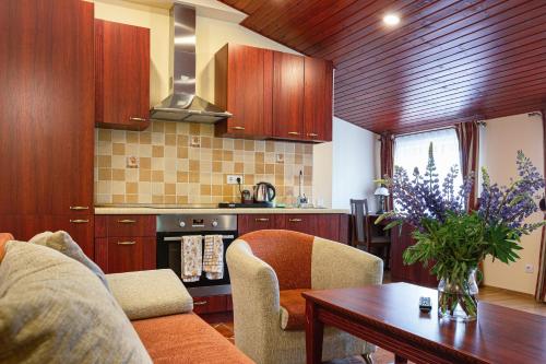 a kitchen with a couch and a table in a room at Galia in Druskininkai