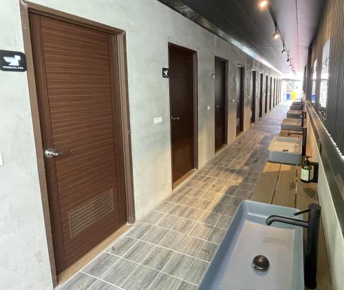 a row of stalls in a bathroom with sinks at Qilin Valley in Puli