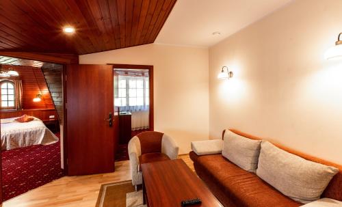 a living room with a couch and a table at Galia in Druskininkai