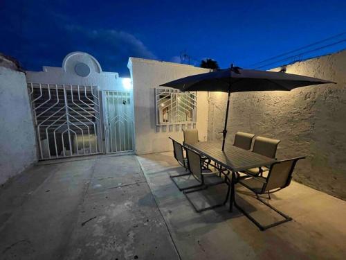- une table et des chaises avec un parasol sur la terrasse dans l'établissement Casa Luxxury Celaya, à Celaya