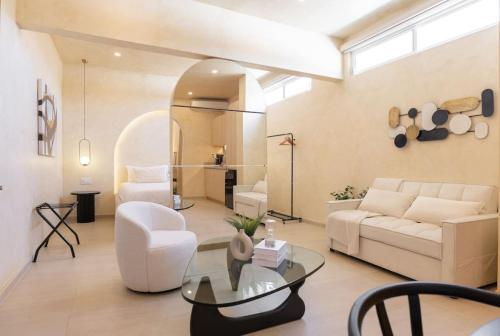 a living room with a white couch and a table at Presidential Studio with Gated Parking at Casas Sanblu in Ensenada