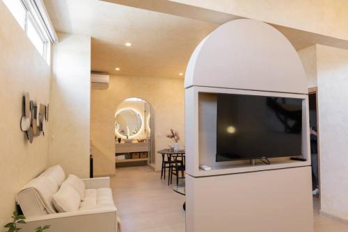 a living room with a flat screen tv in an archway at Presidential Studio with Gated Parking at Casas Sanblu in Ensenada