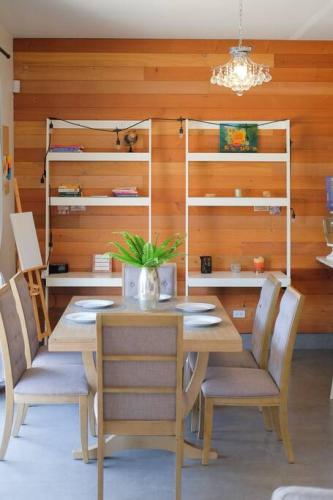 a dining room with a wooden table and chairs at Casa Todos Santos with Gated Parking at Casas Sanblu in Ensenada