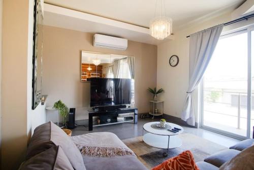 a living room with a couch and a tv at Casa Todos Santos with Gated Parking at Casas Sanblu in Ensenada