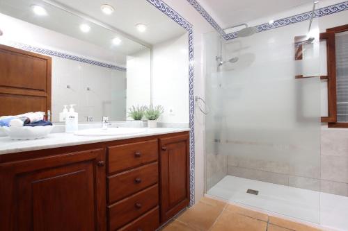 a bathroom with a sink and a shower at Villa Camp Redo in Pollença