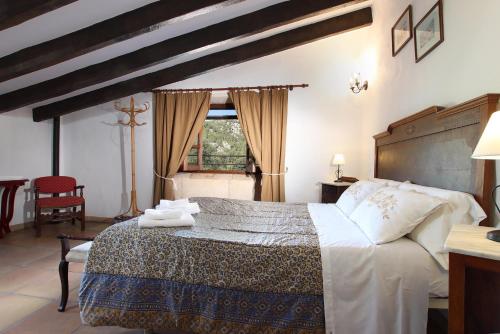 a bedroom with a large bed with towels on it at Villa Camp Redo in Pollença