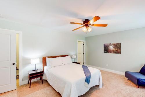 a bedroom with a bed and a ceiling fan at The Retreat at Fern Cove in Pisgah Forest