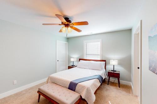 a bedroom with a bed and a ceiling fan at The Retreat at Fern Cove in Pisgah Forest