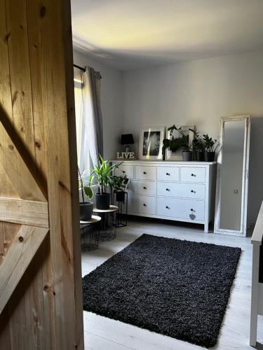 a room with a white dresser with plants on it at Apartament 41 in Jelenia Góra