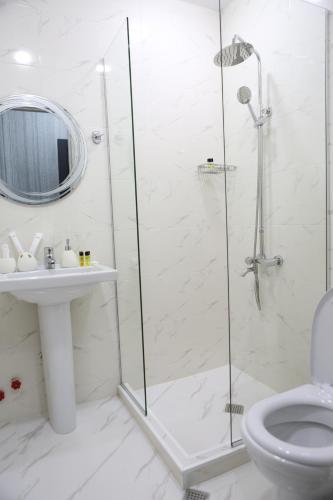 a bathroom with a shower and a toilet and a sink at Luxor Rabath in Akhaltsikhe