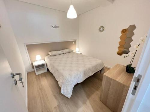 a bedroom with a bed and a wooden floor at HEART OF THE CITY 10 ! in Porto