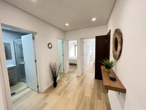 a large room with white walls and a wooden floor at HEART OF THE CITY 10 ! in Porto