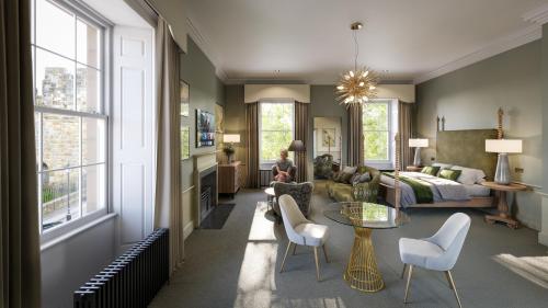 a living room with a bed and a table and chairs at Bailiffgate Hotel in Alnwick