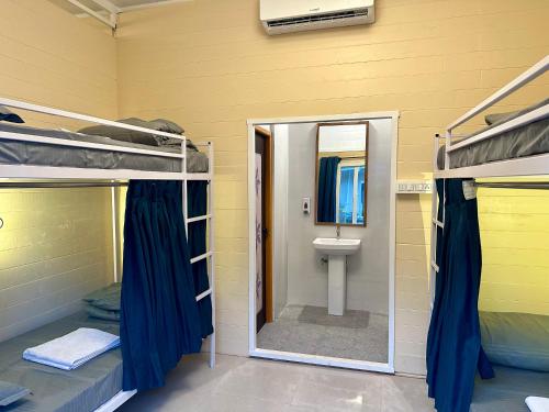 a room with a bathroom with a toilet and bunk beds at Coco Hostel Goa in Palolem
