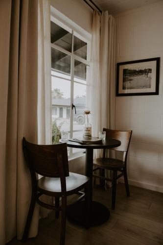 a dining room with a table and chairs and a window at Triangle Motel in Red Bluff