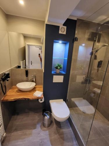 a bathroom with a sink and a toilet and a shower at Liro Hotel Oberhausen in Oberhausen