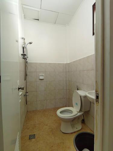 a bathroom with a toilet and a sink at HOST HOMES - CASA ELIZA in Tacloban