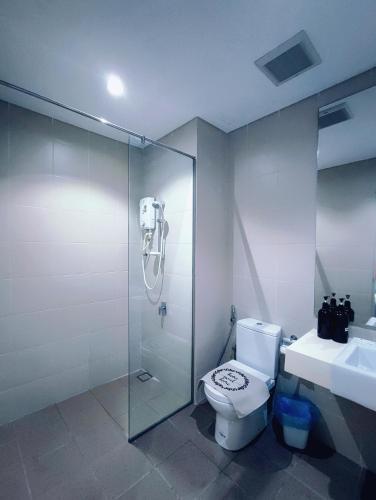 a bathroom with a shower and a toilet and a sink at I-City 2-Bedroom - Great Value Homestay By Atlantis Management in Shah Alam