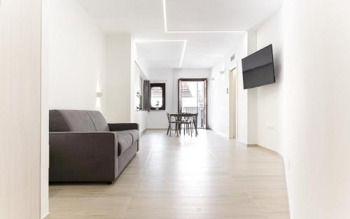 a living room with a couch and a television on a wall at Appartamento comfort-relax in Termoli