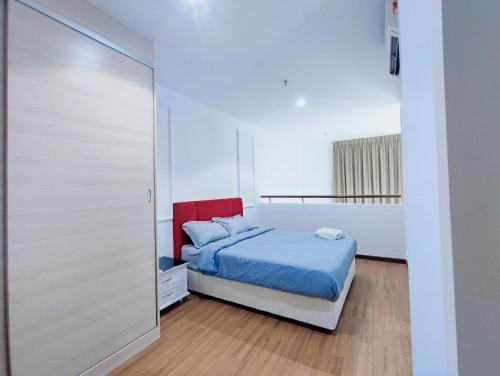 a bedroom with a bed and a sliding glass door at I-City 2-Bedroom - Great Value Homestay in Shah Alam
