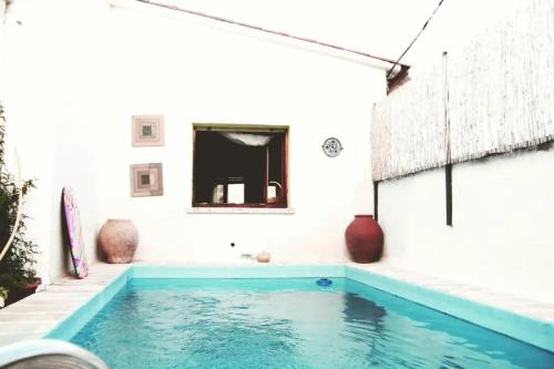a swimming pool in a room with a white wall at Casita de Bosque in Arbúcies
