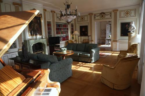 a living room with a couch and a fireplace at Mauritzbergs Slott & Golf in Mauritsberg