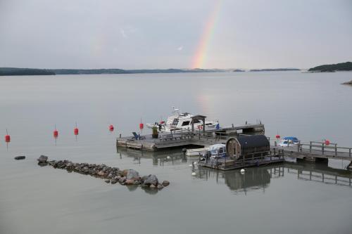 a boat docked at a dock with a rainbow in the background at Mauritzbergs Slott & Golf in Mauritsberg